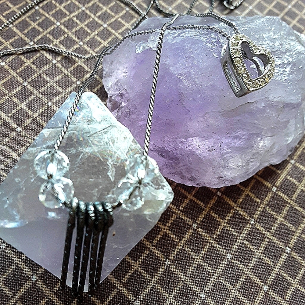 2 necklaces, a heart pendant w/ chain & a crystal bead & metal charms.